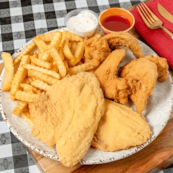 A G'Ville Seafood N' Chicken platter with fried fish, chicken wings, crinkle-cut fries, and dipping sauces.