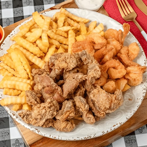 A platter of G'Ville Seafood N' Chicken's fried shrimp, fried chicken, and french fries.