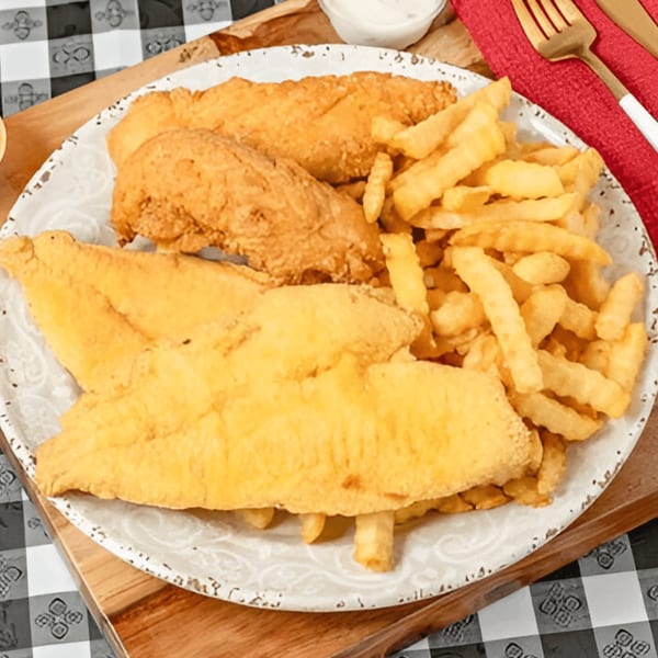 G'Ville Seafood N' Chicken's fried fish and chicken tenders with french fries on a white plate.