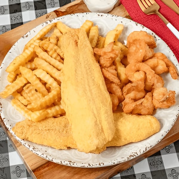 A plate of G'Ville Seafood N' Chicken's fried fish, shrimp, and crinkle-cut fries.