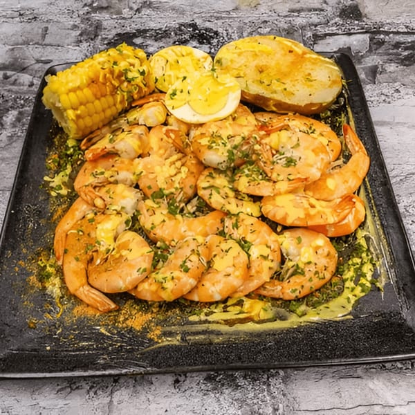 G'Ville Seafood N' Chicken's shrimp platter with corn on the cob, potatoes, and a hard-boiled egg.